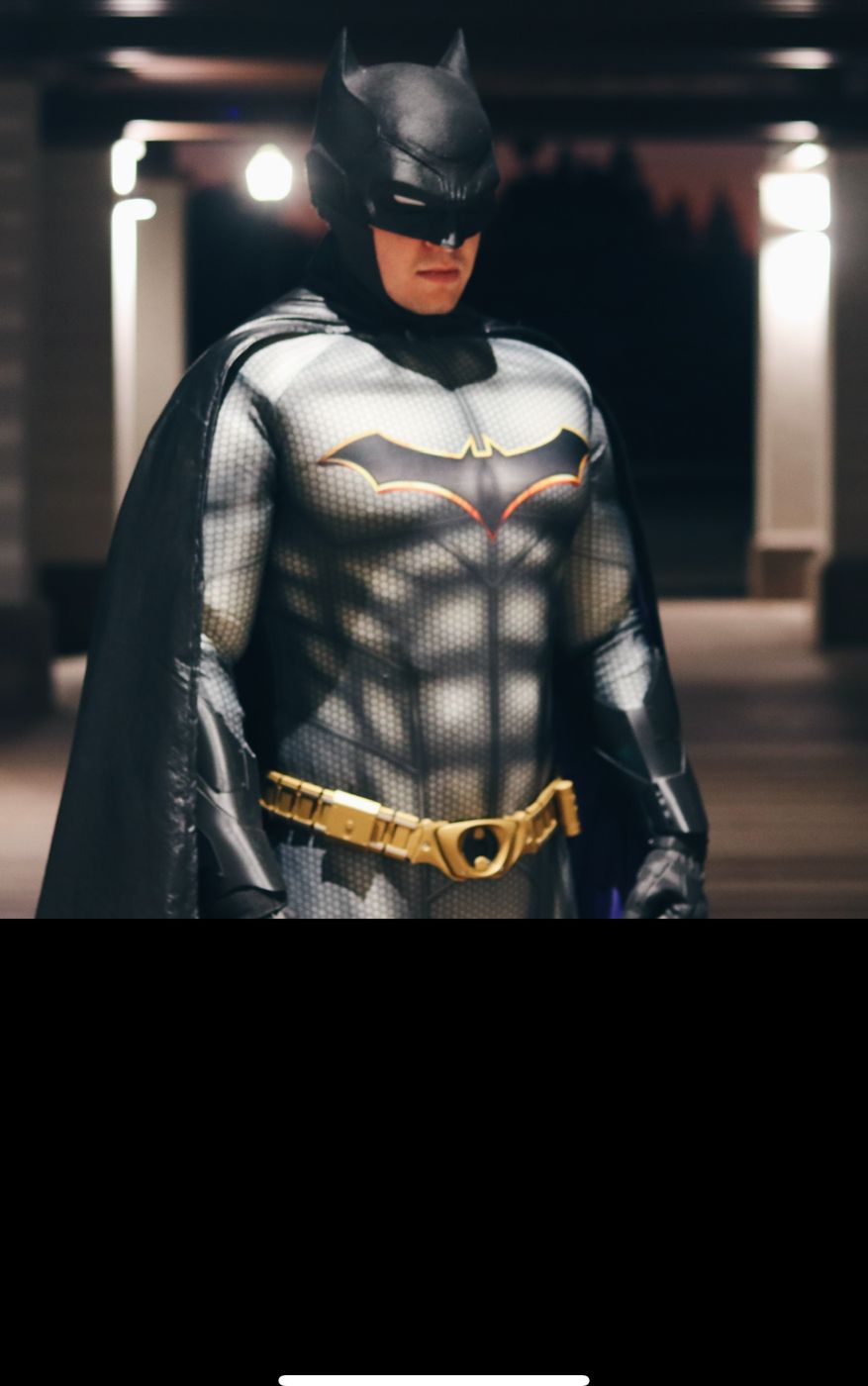 Dark knight hero character in armored suit at night