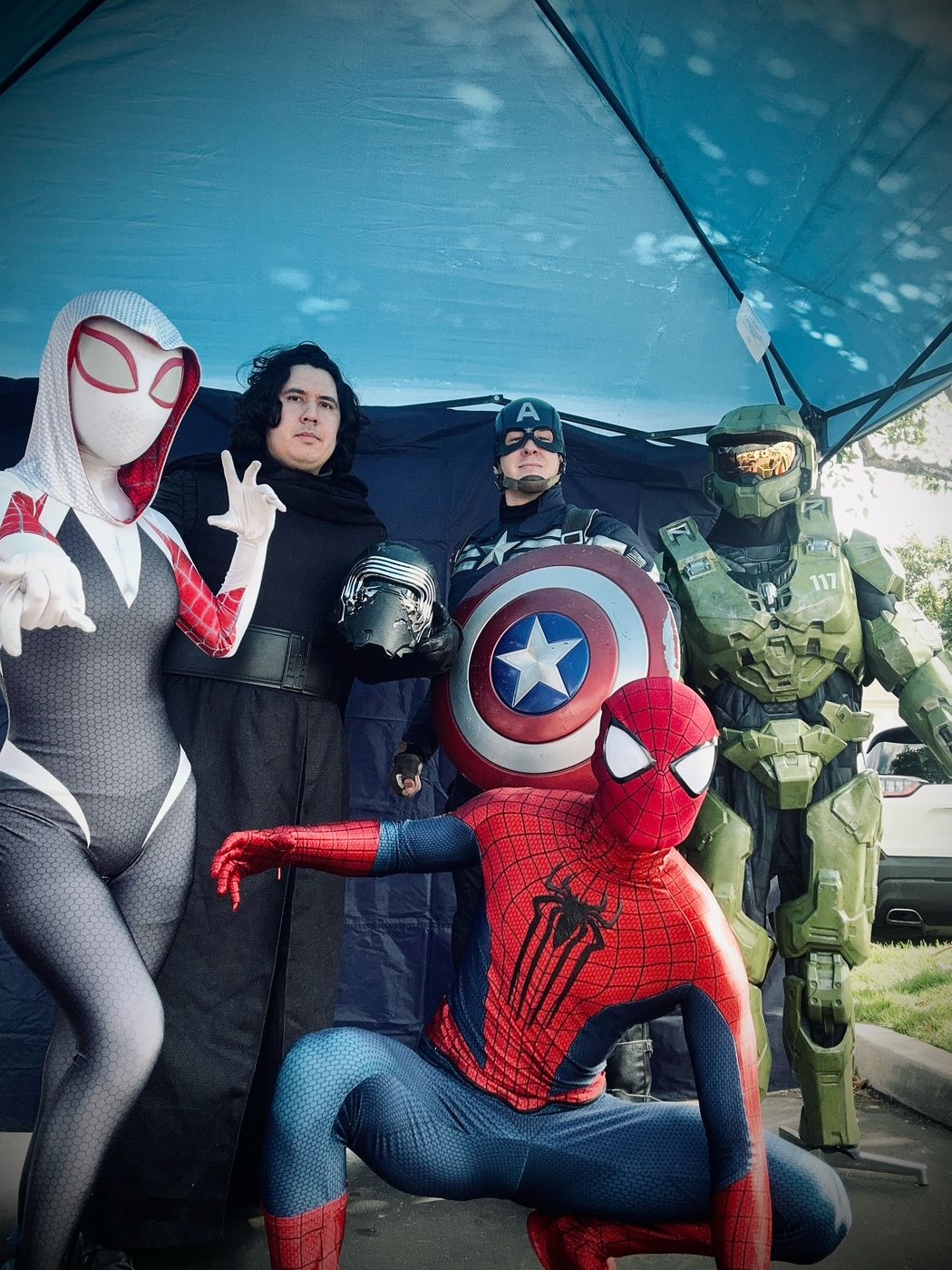 Ghost spider, space villain, patriotic hero, armored spartan, and spider hero at a community event