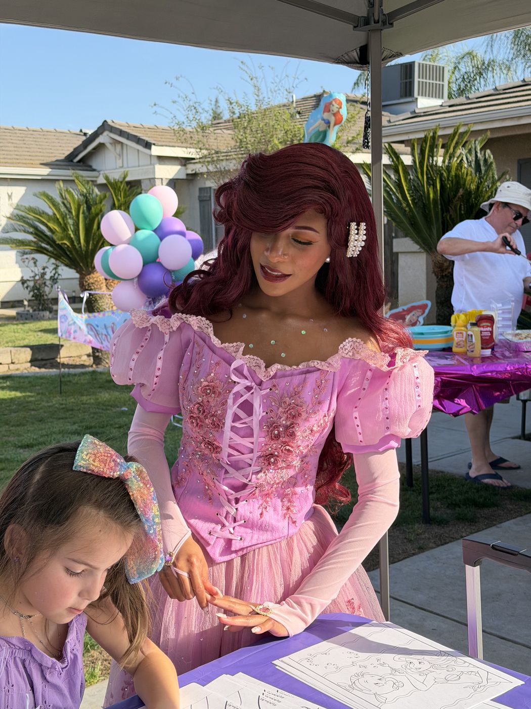 Mermaid princess character coloring with a child at a Fresno birthday party